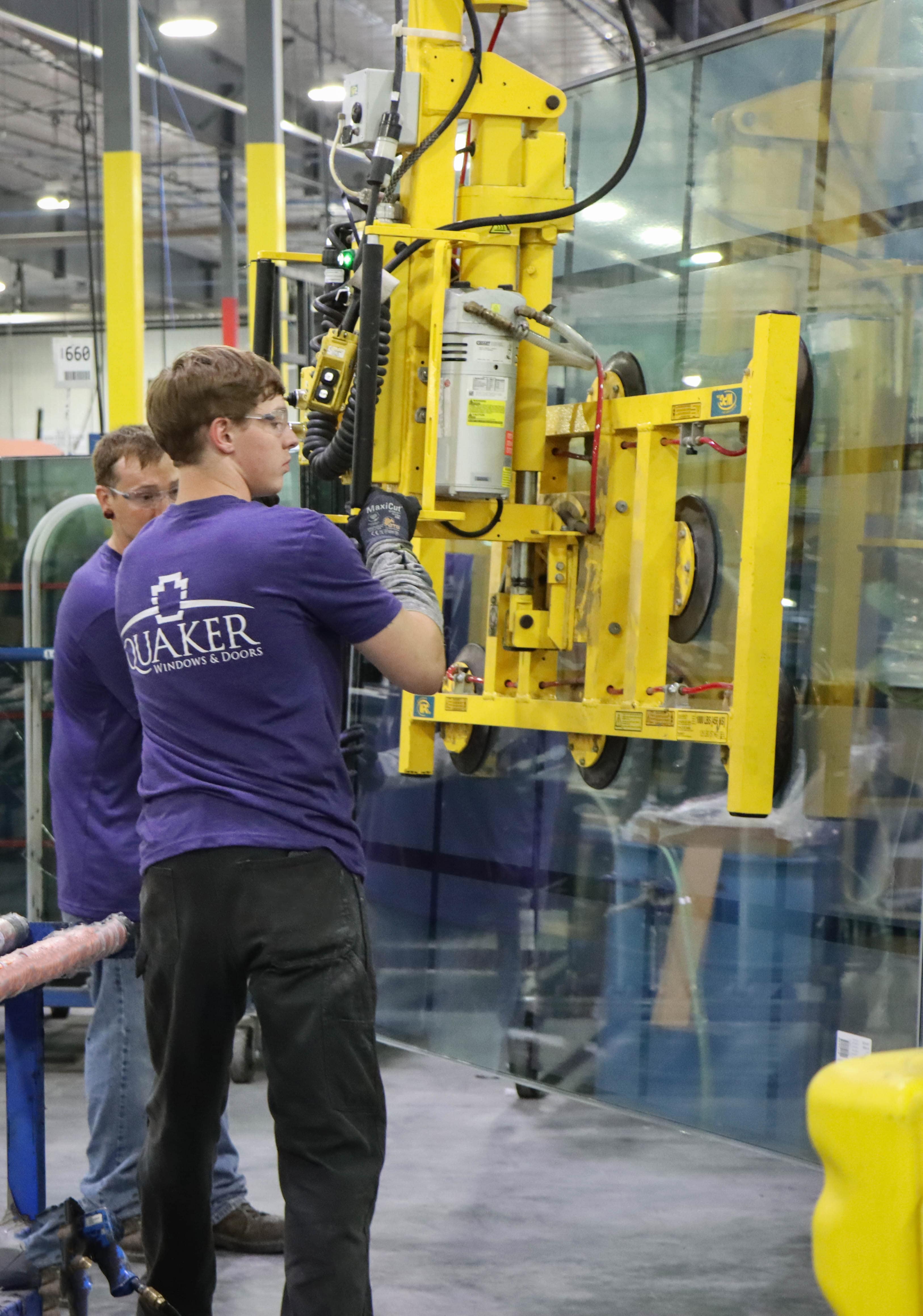 Employees using robots to assist with moving products