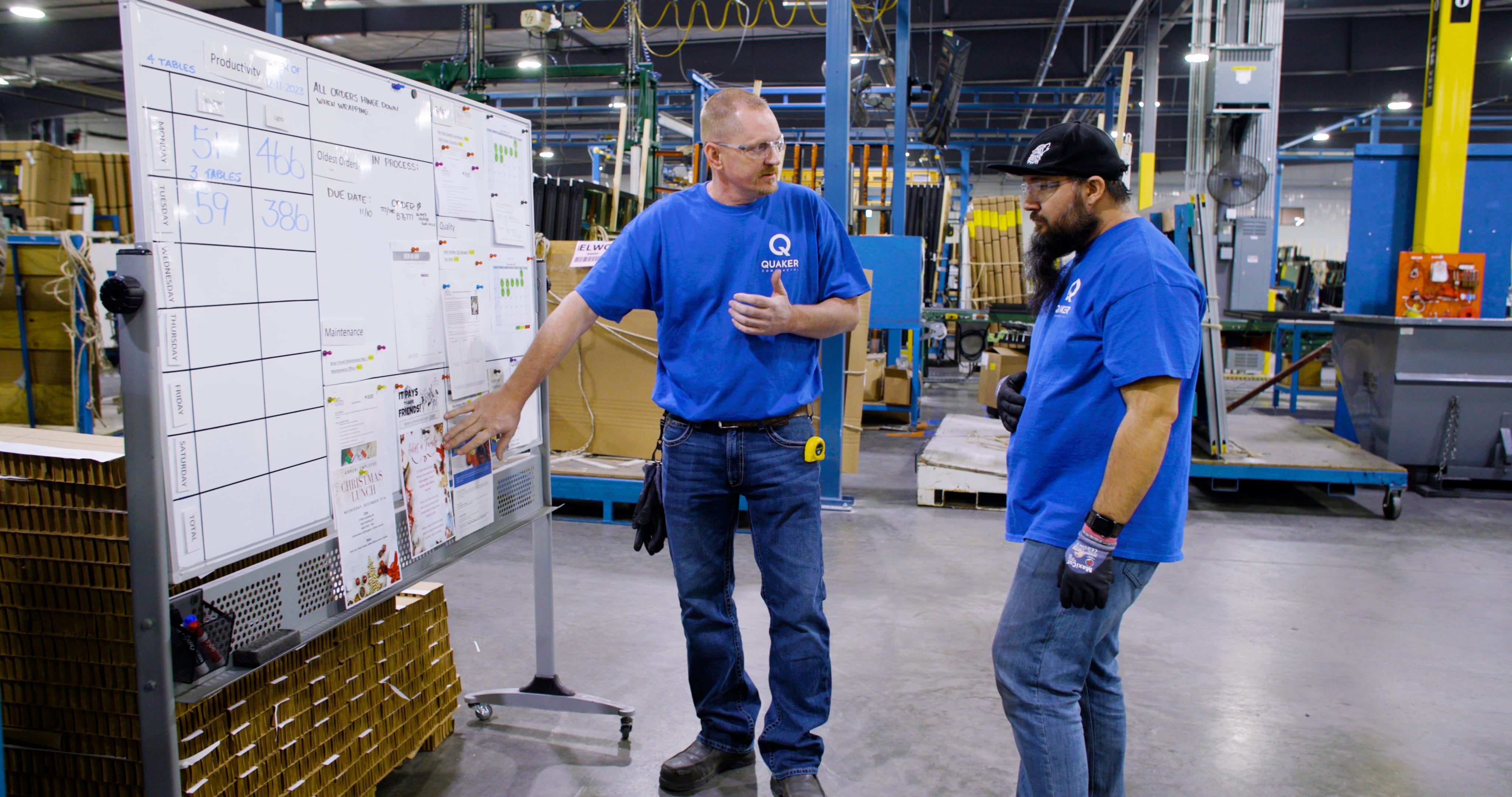 Quaker team members review production schedules